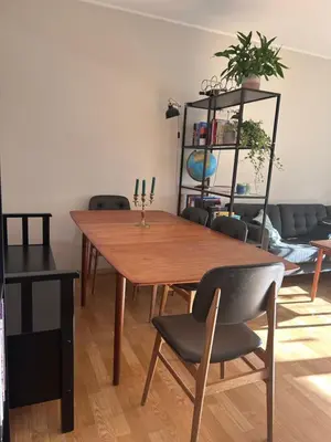 a dining room with a wooden table and chairs at 2 bed apartment in Trondheim