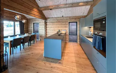 a kitchen with a island in the middle of a room at Amazing Home In Øyer With Wifi in Øyer