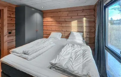 a large white bed in a room with a window at Amazing Home In Øyer With Wifi in Øyer