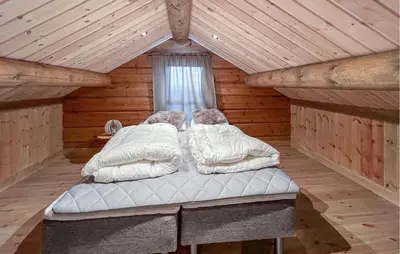 a bedroom with two beds in a log cabin at Amazing Home In Øyer With Wifi in Øyer