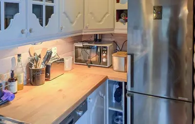 a kitchen with a counter top with a microwave at Beach Front Home In Omastrand in Gjuvsland
