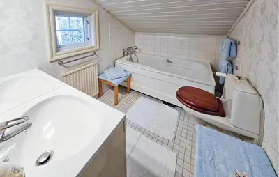 a bathroom with a tub and a sink and a toilet at 4 Bedroom Beautiful Home In Hemsedal in Hemsedal
