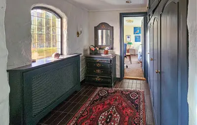 a hallway with a room with a dresser and a window at 4 Bedroom Beautiful Home In Hemsedal in Hemsedal