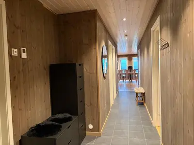 a hallway of a house with a wooden wall at Stor leilighet på Bualie, Golsfjellet in Gol