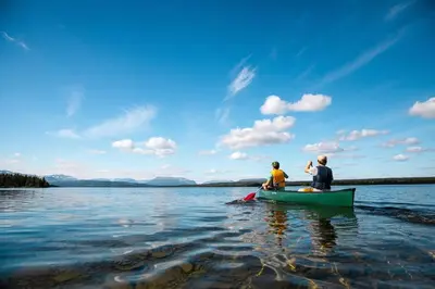 two people sitting in a canoe on a lake at Stor leilighet på Bualie, Golsfjellet in Gol