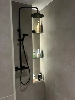 a bathroom with a shower with a shower head at Villa til leie under SKI-VM in Trondheim