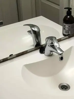 a bathroom sink with a faucet in front of a mirror at Trondhjemsvegen in Gjøvik