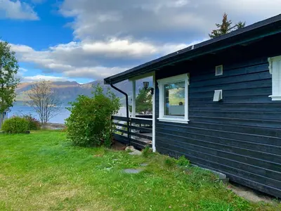 a blue house with a window on the side of it at Cabin 