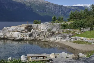 a picnic table sitting on the shore of a lake at Cabin 