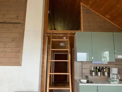 a kitchen with a ladder next to a sink at Cabin 