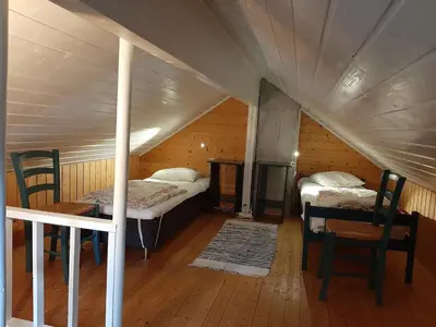 a room with two beds and a table and chairs at Cabin 