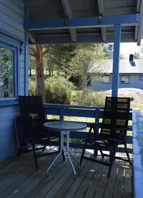 a table and two chairs on a porch at Cabin 