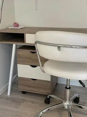 a white chair sitting next to a desk at Bright Modern Apartment - Prime Location in Ålesund