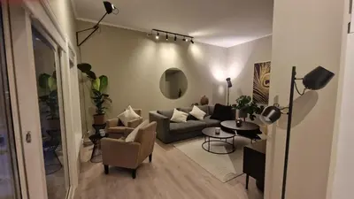 a living room with a couch and a table at Modern apartment with stunning view over city in Trondheim