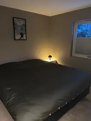 a bedroom with a large bed and a window at Beautiful house - walking distance of everything in Trondheim
