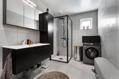a bathroom with a washing machine and a washer at Beautiful house - walking distance of everything in Trondheim
