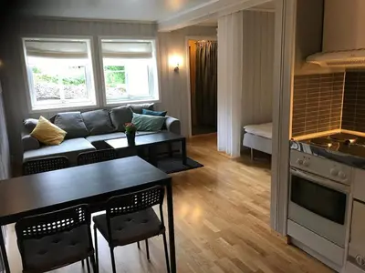 a living room with a couch and a table at Bright and nice apartment in Trondheim