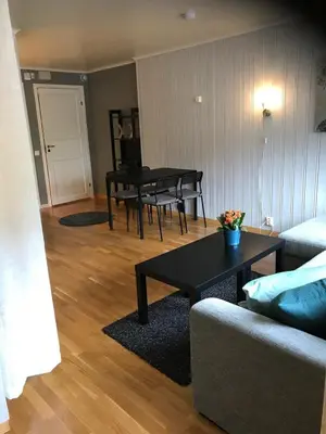 a living room with a couch and a table at Bright and nice apartment in Trondheim