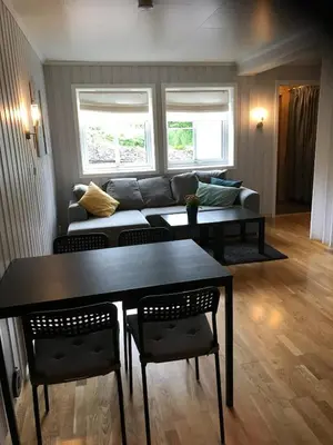 a living room with a table and a couch at Bright and nice apartment in Trondheim