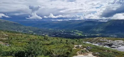a view of a valley with a river and mountains at Panorama Cabin - Stunning Mountain Views and Outdoor Jacuzzi Option in Bjorli