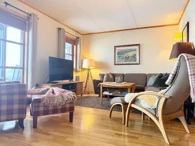 a living room with a couch and a tv at Perfectly Located-Close To Ski Slopes And Hiking Trails in Beitostøl