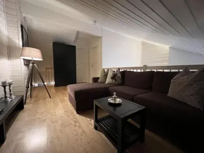 a living room with a couch and a table at Stylish 4-Bedroom Apartment With Mountain Views! in Beitostøl