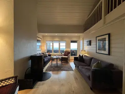 a living room with a couch and a table at Stylish 4-Bedroom Apartment With Mountain Views! in Beitostøl