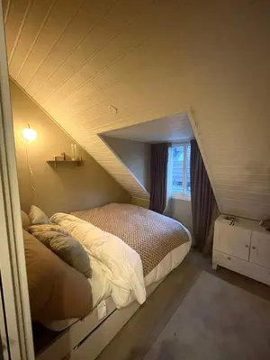 a bedroom with a bed in a attic at City View, stylish loft apartment and Central Location in Trondheim