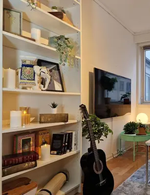 a living room with a guitar and a tv at Cozy condo near Bryggen Full kitchen Elevator in Bergen