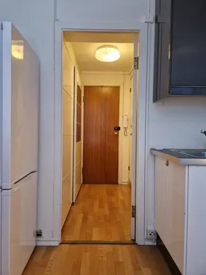 a hallway with a kitchen and a door to a room at Cozy condo near Bryggen Full kitchen Elevator in Bergen