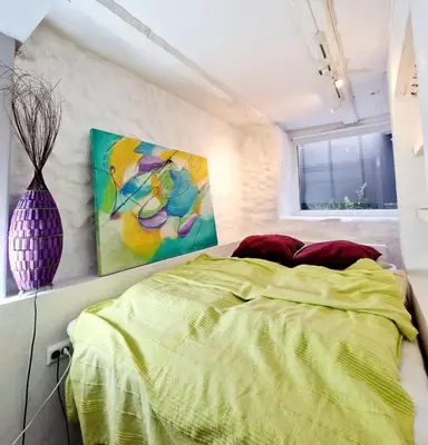 a bedroom with a bed and a painting on the wall at Beautiful condo near Bryggen Balcony Fireplace in Bergen