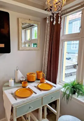 a table with two sinks in a room with a window at Sleep well in Heart of Bergen - Beautiful street in Bergen