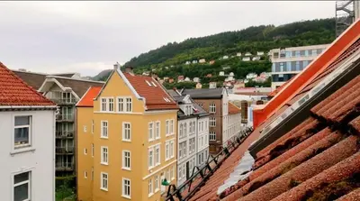 a view of a city with buildings and mountains at Top Floor Close to Grieg Hall and Town Square in Bergen