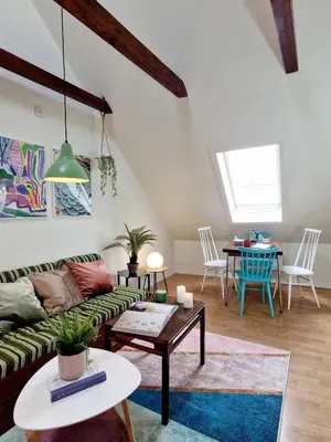 a living room with a couch and a table at Top Floor Close to Grieg Hall and Town Square in Bergen