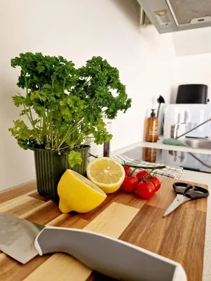 a knife on a cutting board with a lemon and vegetables at City center Terrace in quiet backyard - Stylish in Bergen