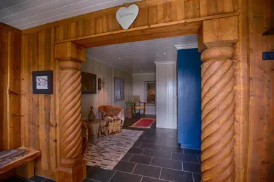 a hallway with a wooden wall with a heart on it at Spacious Cabin With Sauna & Scenic Terrace in Beitostøl