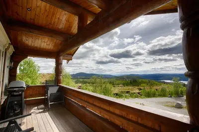 a porch of a cabin with a view of the mountains at Spacious Cabin With Sauna & Scenic Terrace in Beitostøl
