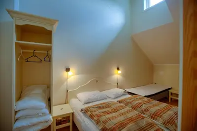 a small bedroom with a bed and a window at Central Stay With Balcony, Ideal For Small Family in Beitostøl