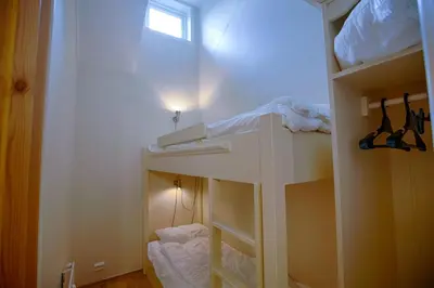a white bunk bed in a room with a window at Central Stay With Balcony, Ideal For Small Family in Beitostøl
