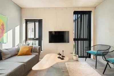 a living room with a couch and a table at The Double Date I Architectural Gem in Bergen
