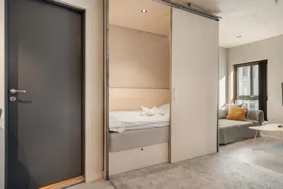 a bedroom with a door leading to a bed at The Double Date I Architectural Gem in Bergen