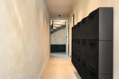 a hallway with a black refrigerator in a room at The Double Date I Architectural Gem in Bergen