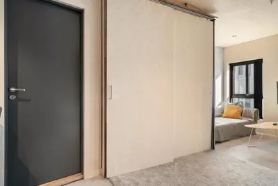 a sliding door leading into a living room with a couch at The Double Date I Architectural Gem in Bergen