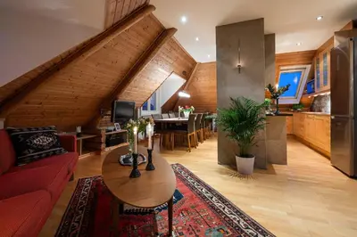 a living room with a red couch and a table at Cozy downtown apartment in Trondheim