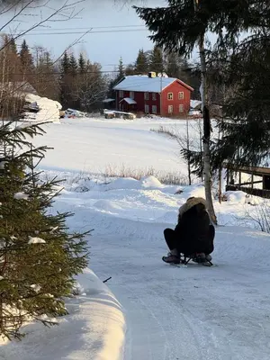 a person sitting in the snow on a snowboard at Holiday Cabin with Hot Tub and Billiard Table in Tyndrom