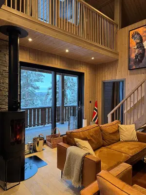 a living room with a couch and a wood stove at Holiday Cabin with Hot Tub and Billiard Table in Tyndrom