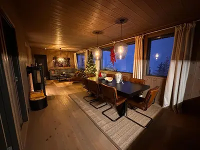 a dining room with a table and chairs in a room at Hafjell Front 220B 8pers Ski InOut, Downhill bike in Hunder