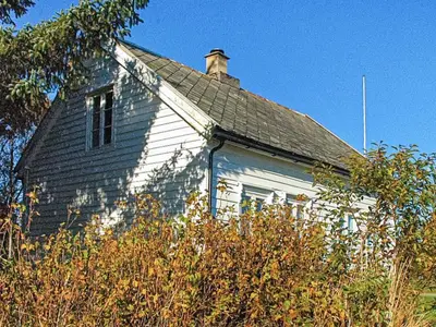 a white house with a window and a roof at 6 person holiday home in Fjørtoft in Fjørtoft