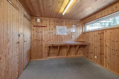 a wooden room with a wooden paneled wall at Utsiktsleilighet med ski in out på Hafjell 7 sengeplasser in Hunder