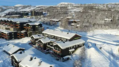 a resort in the snow with snow covered buildings at Family-Friendly Retreat With Fireplace And Balcony in Beitostøl